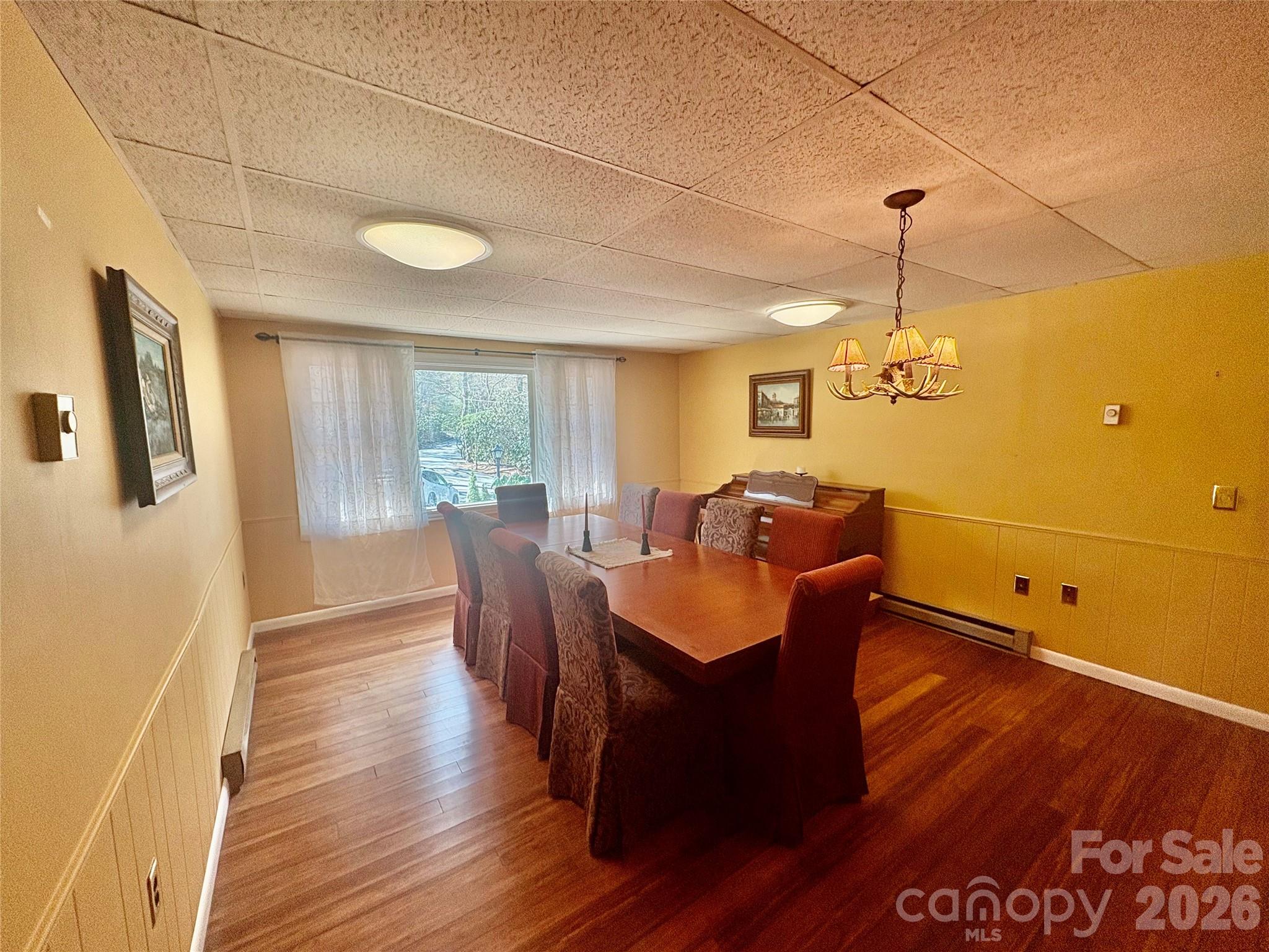 126 Ridgeview Road Spruce Pine, NC 28777 - Photo 15 of 39 a view of a dining room with furniture window and wooden floor