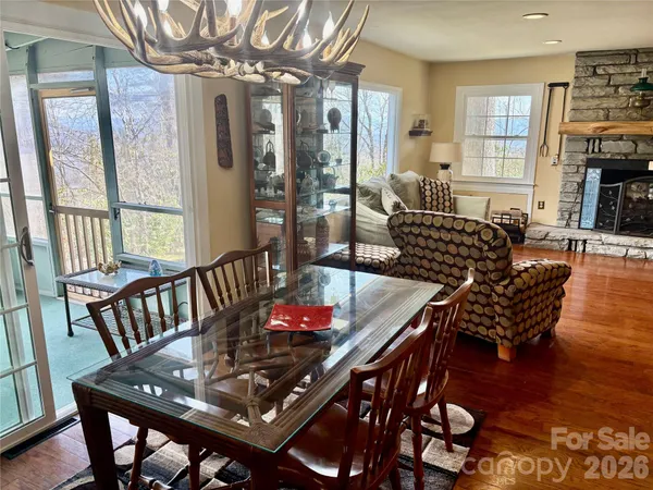 a view of a dining room with furniture wooden floor and chandelier