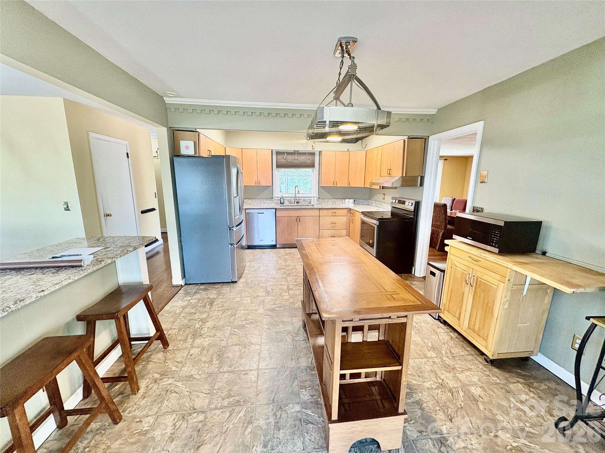 126 Ridgeview Road Spruce Pine, NC 28777 - Photo 9 of 39 a room with stainless steel appliances kitchen island granite countertop furniture and a kitchen view