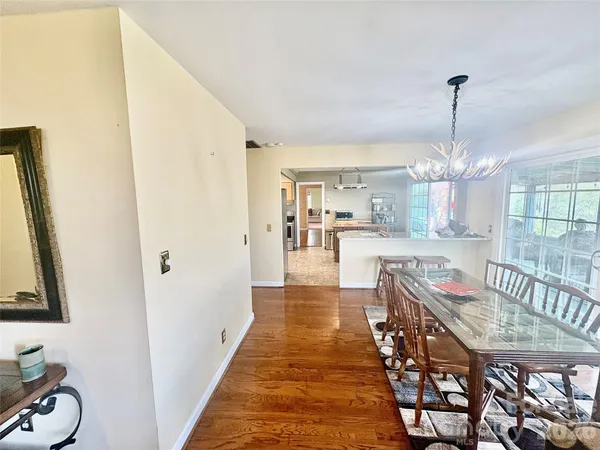 a dining room with furniture and chandelier