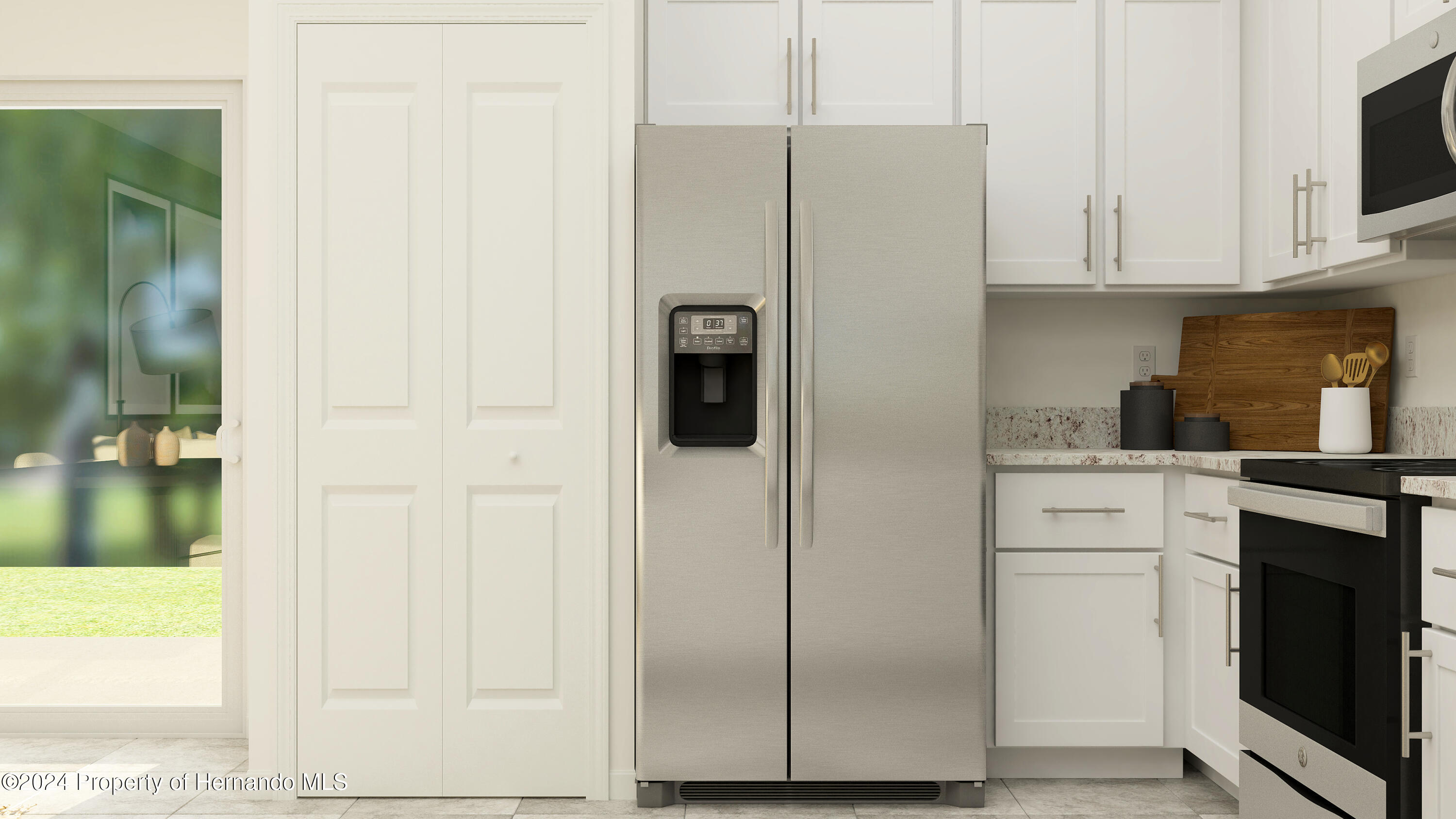 11053 Wishing Cloud Road Land O Lakes, FL 34638 - Photo 5 of 9 a kitchen with a refrigerator and cabinets