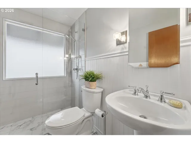 a bathroom with a sink toilet and a mirror