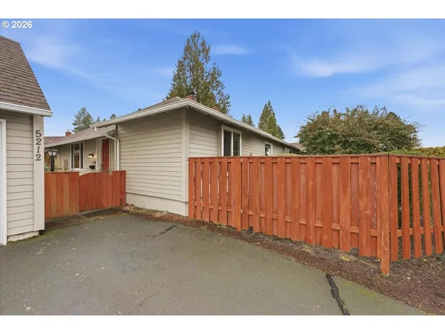 a view of a house with wooden fence