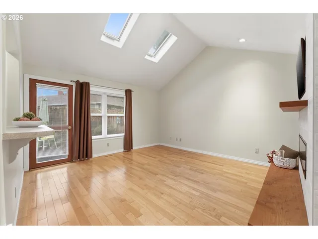 a view of empty room with wooden floor