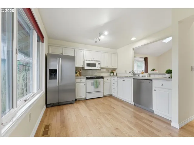 a kitchen with stainless steel appliances a refrigerator sink and cabinets