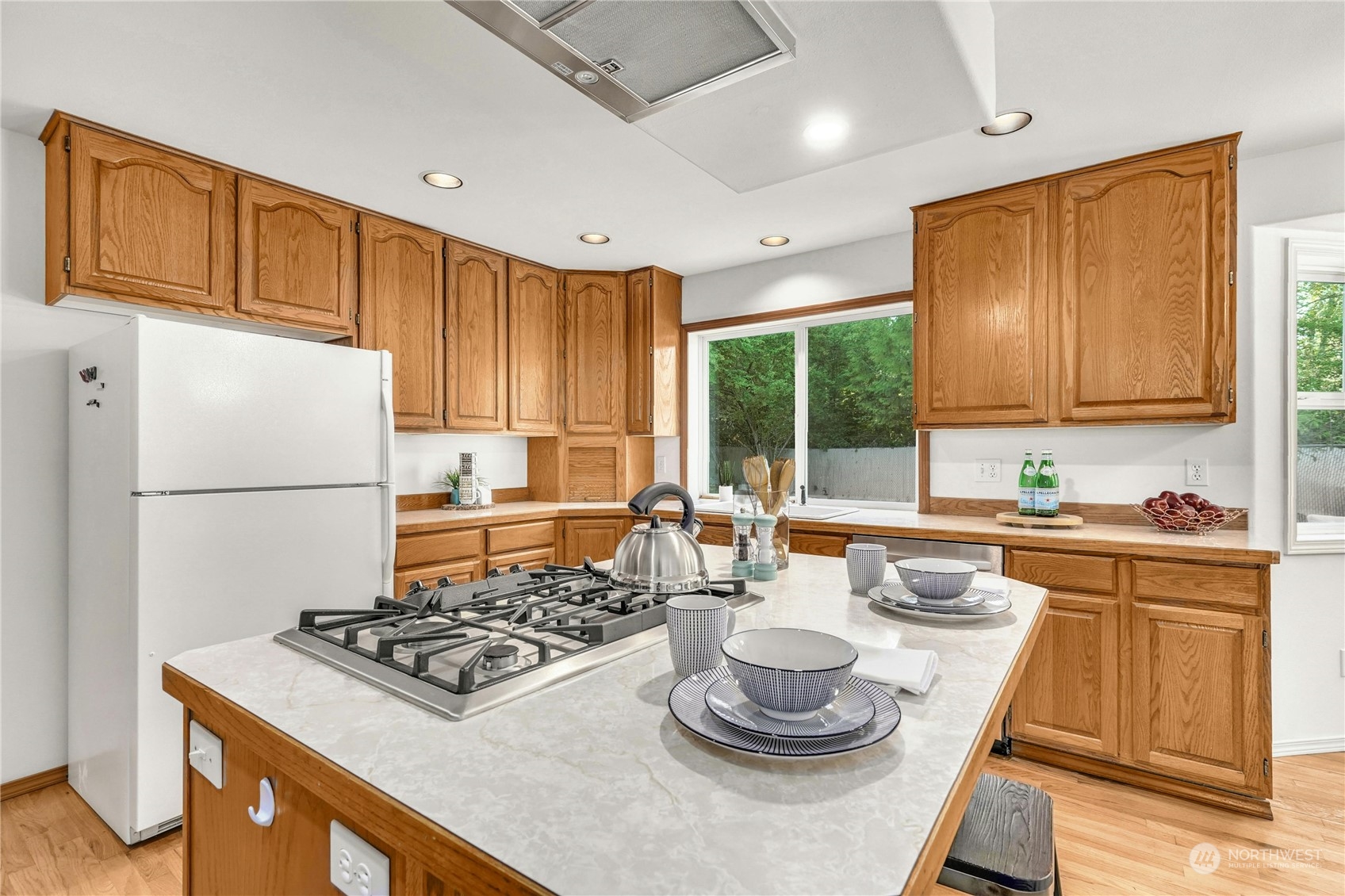 1519 232nd Place Southwest Bothell, WA 98021 - Photo 12 of 31 a kitchen with a stove a sink dishwasher and white refrigerator with wooden cabinets