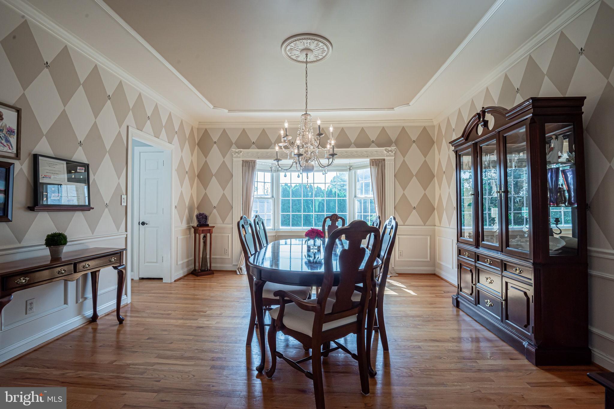 706 Regency Hill Road Hockessin, DE 19707 - Photo 12 of 54 a view of a dining room with furniture window and wooden floor