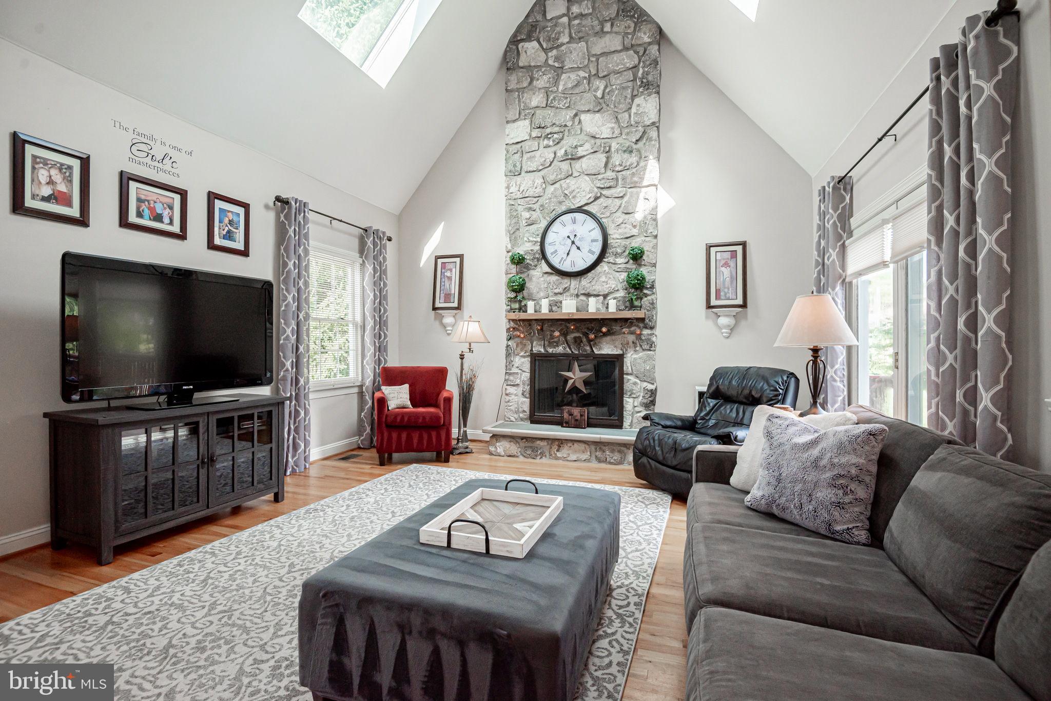706 Regency Hill Road Hockessin, DE 19707 - Photo 21 of 54 a living room with furniture a flat screen tv and a fireplace