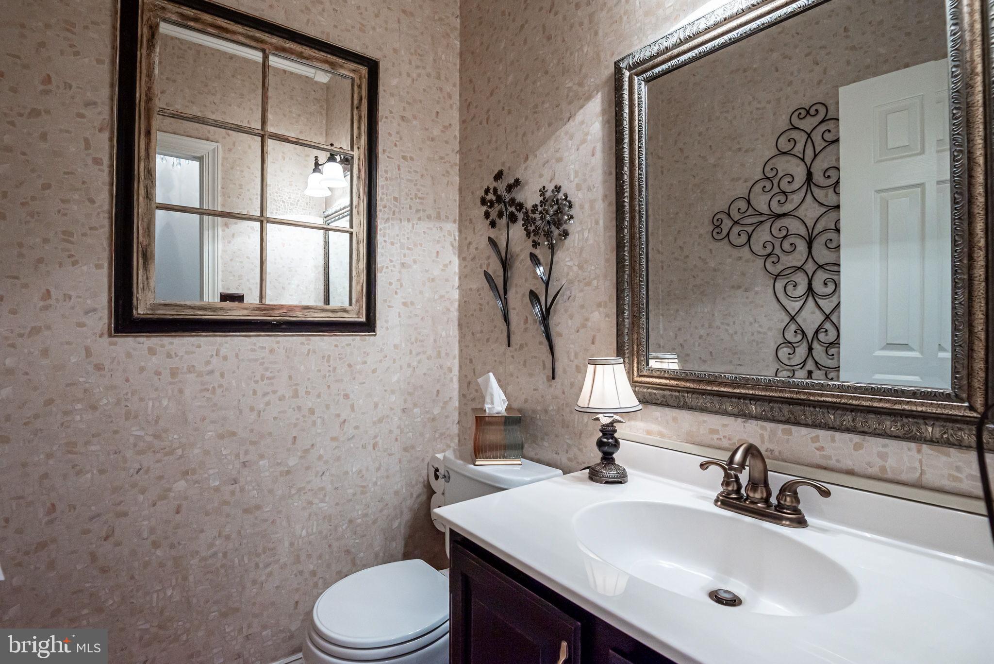 706 Regency Hill Road Hockessin, DE 19707 - Photo 26 of 54 a bathroom with a sink and mirror with toilet