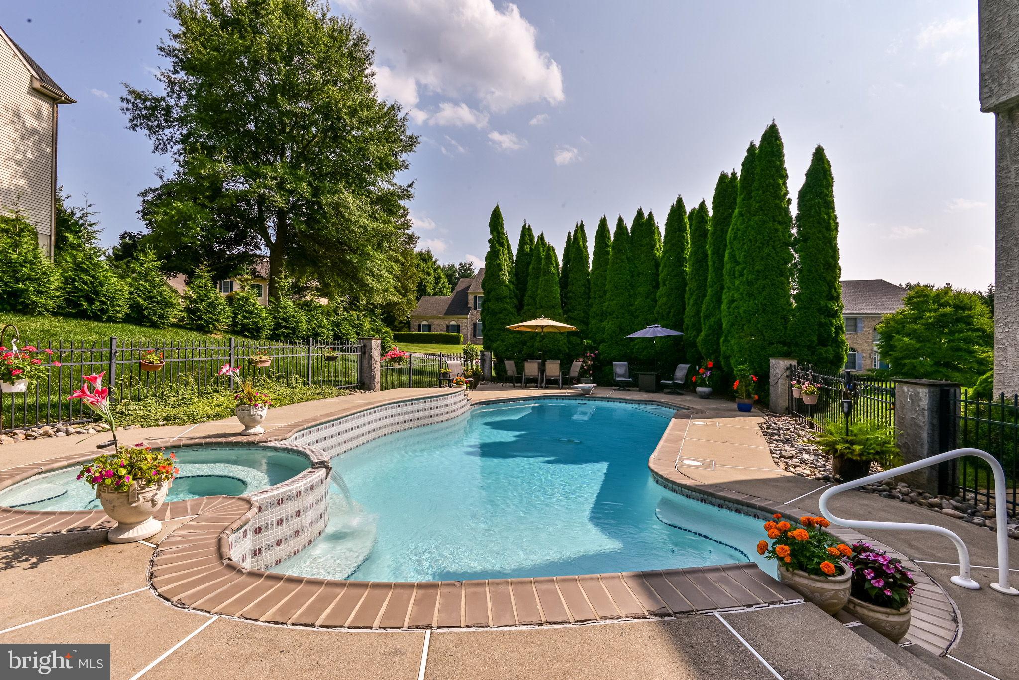 706 Regency Hill Road Hockessin, DE 19707 - Photo 41 of 54 a view of a swimming pool with a patio and a garden