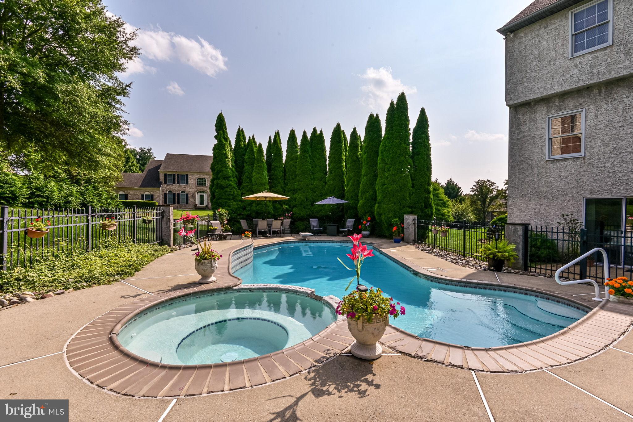 706 Regency Hill Road Hockessin, DE 19707 - Photo 43 of 54 a view of a swimming pool with a garden and trees