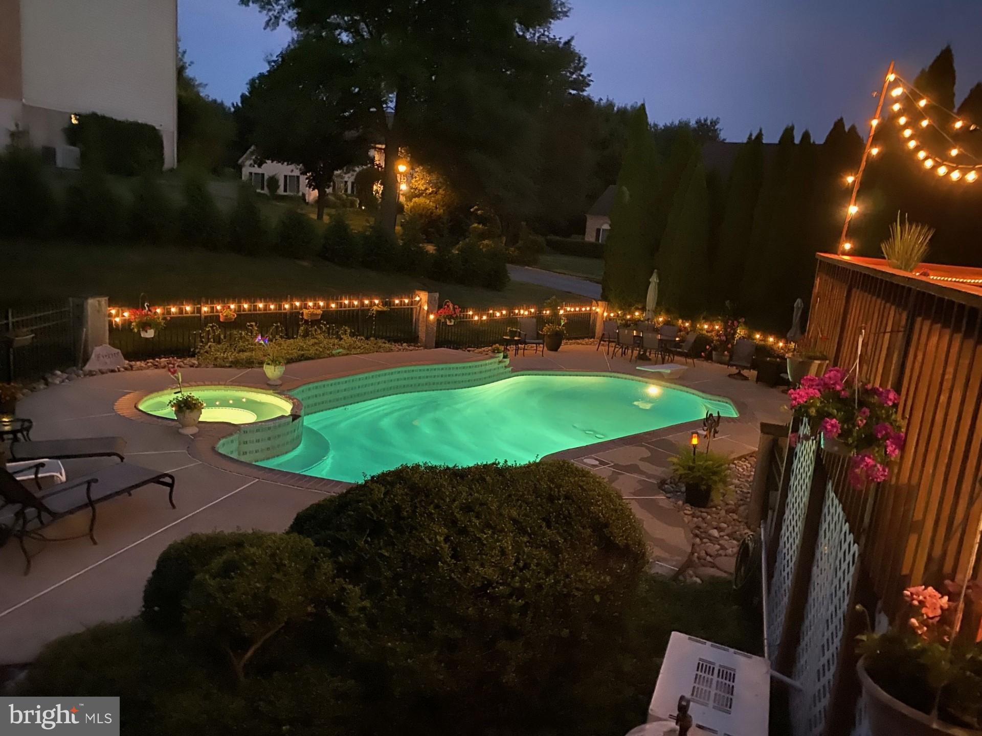 706 Regency Hill Road Hockessin, DE 19707 - Photo 48 of 54 a view of a swimming pool with an outdoor space and seating area