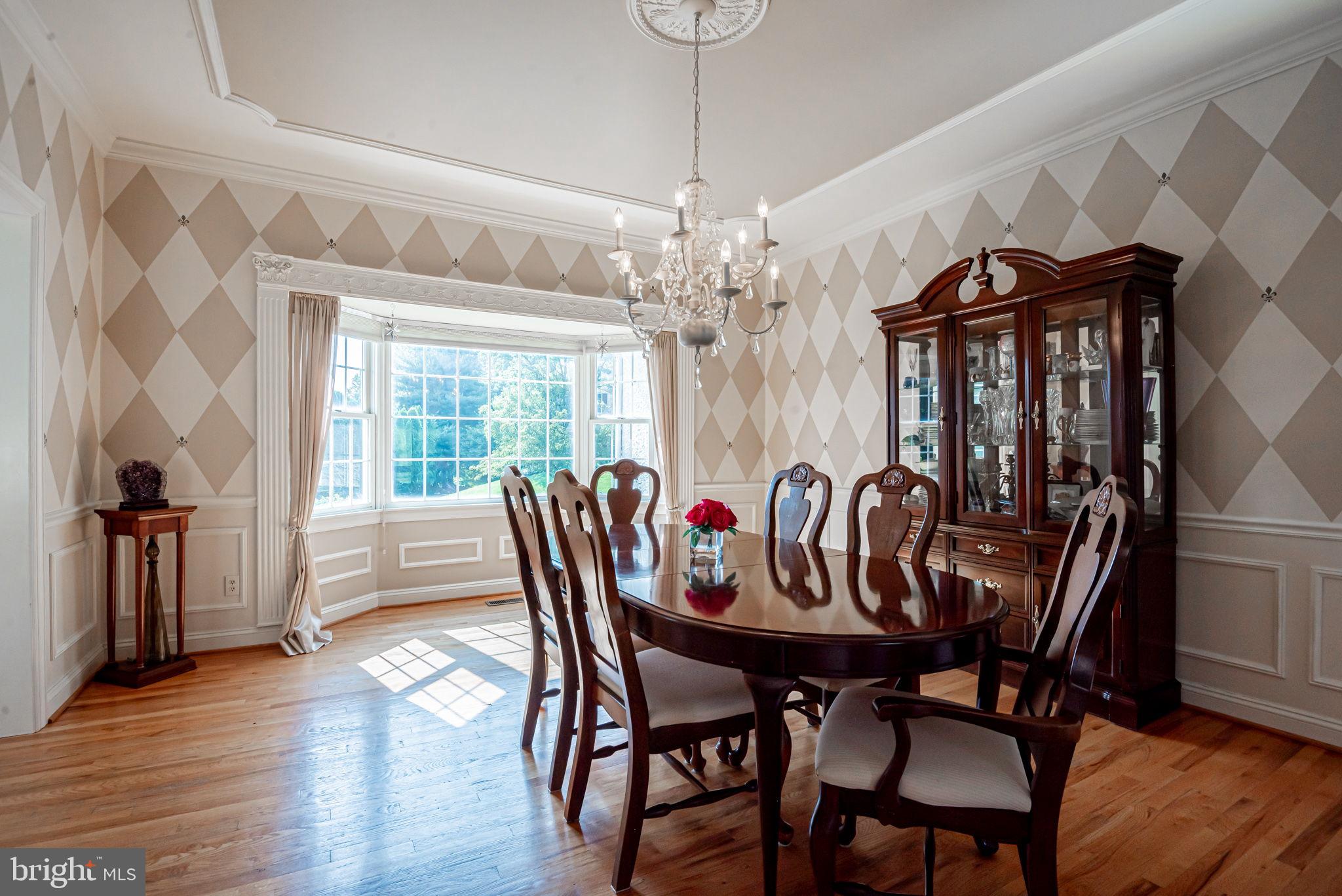 706 Regency Hill Road Hockessin, DE 19707 - Photo 10 of 54 a dining room with furniture a chandelier and wooden floor