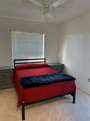 a bed sitting in a room next to a cabinet