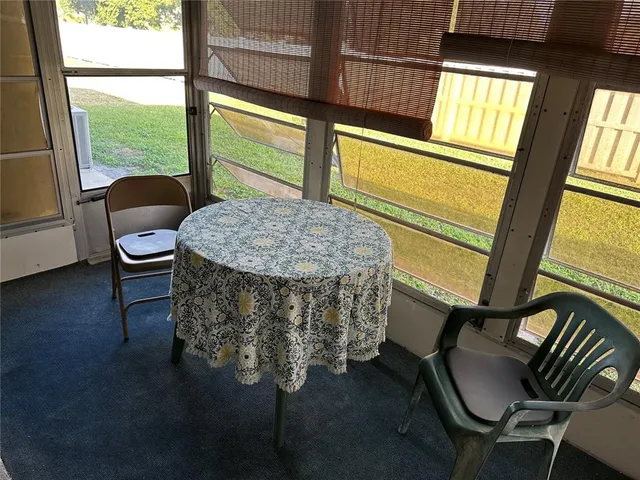a room with a chair and a large window