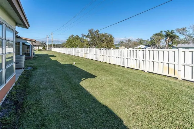 a front view of a house with garden and garage