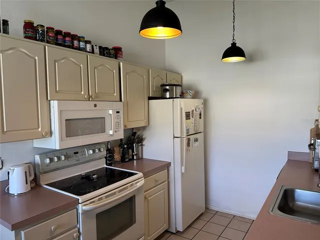a kitchen with cabinets and appliances