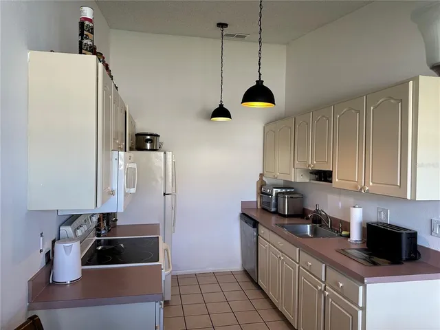 a kitchen with a sink a stove and cabinets