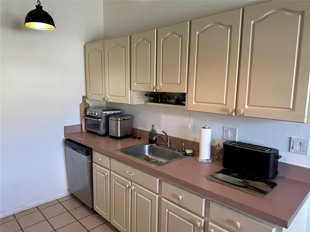 a kitchen with stainless steel appliances granite countertop a sink a stove and a microwave