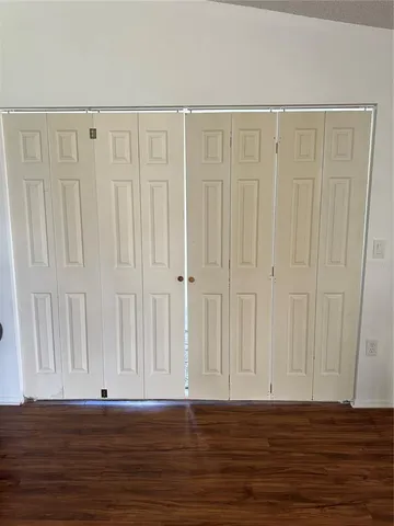a view of wooden floor with entryway