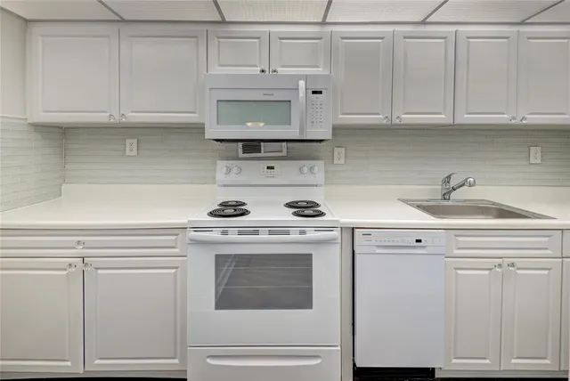 a kitchen with a stove and a refrigerator