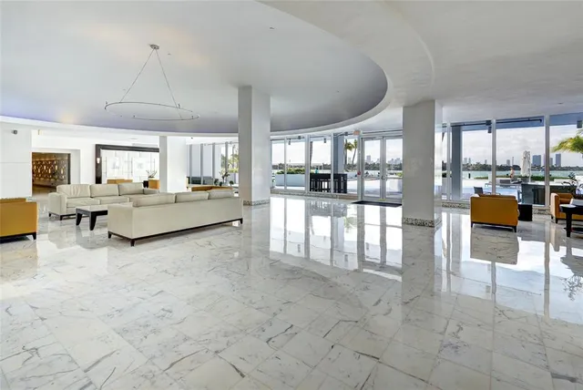 a front view of a building with palm trees