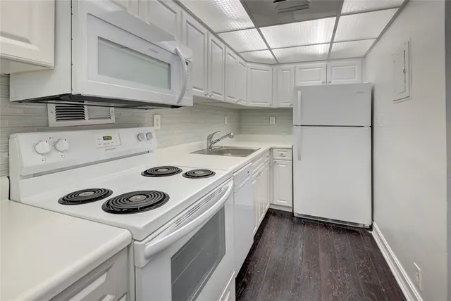a kitchen with a stove and a refrigerator