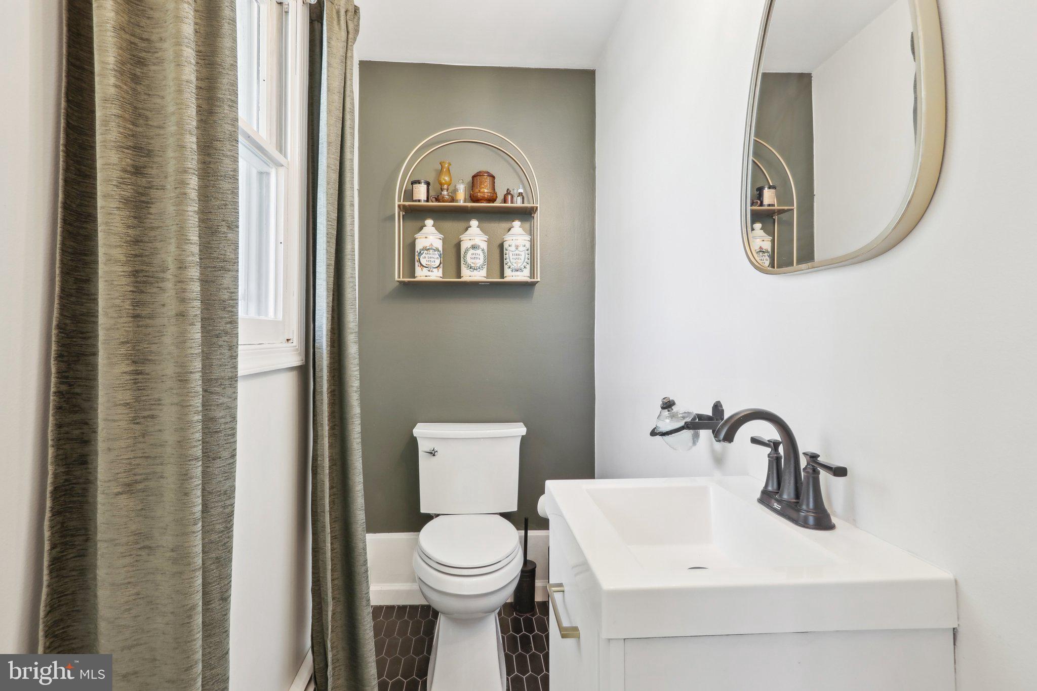 2305 Huntingdon Road Huntingdon Valley, PA 19006 - Photo 15 of 57 a bathroom with a toilet sink and mirror