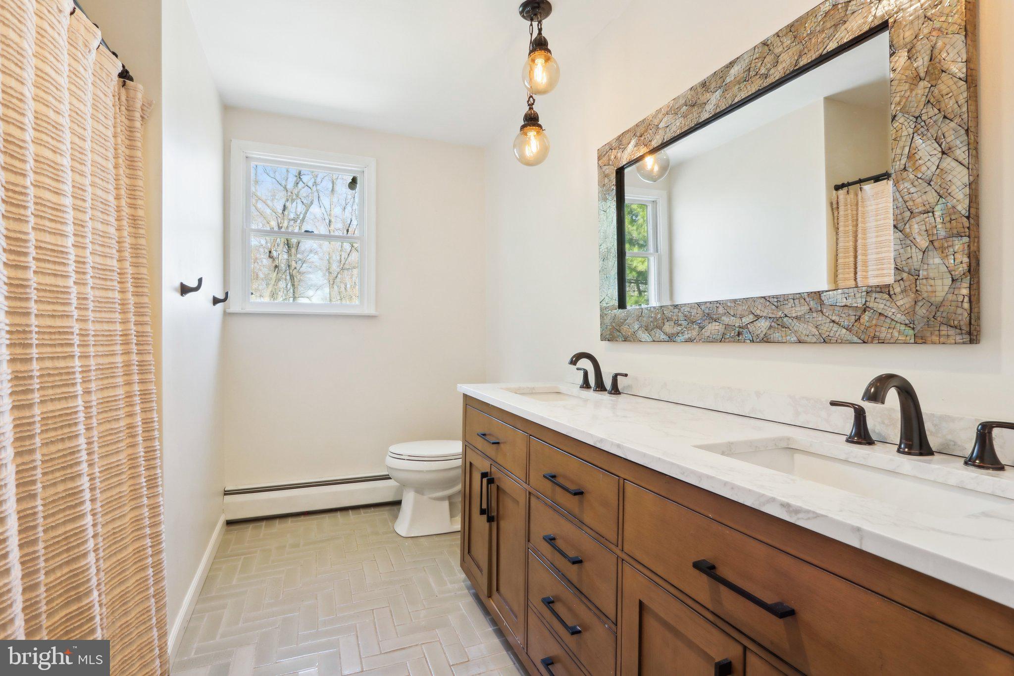 2305 Huntingdon Road Huntingdon Valley, PA 19006 - Photo 28 of 57 a bathroom with a double vanity sink toilet and a mirror