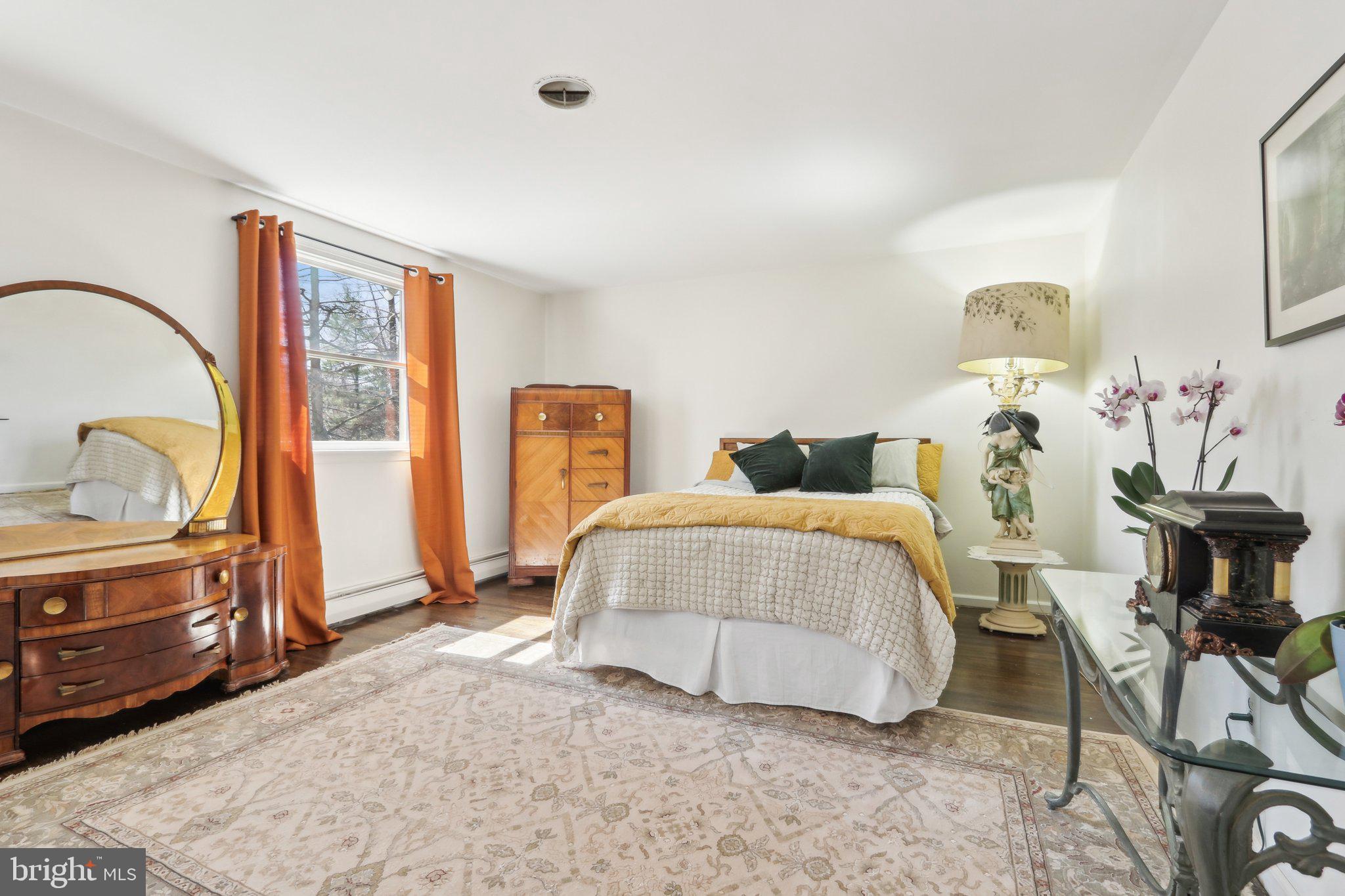 2305 Huntingdon Road Huntingdon Valley, PA 19006 - Photo 29 of 57 a bedroom with a bed and dresser with mirror