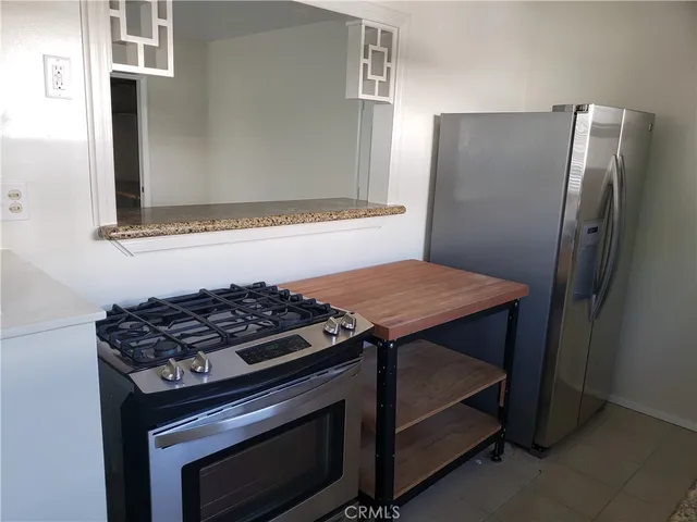 a kitchen with a stove and a refrigerator