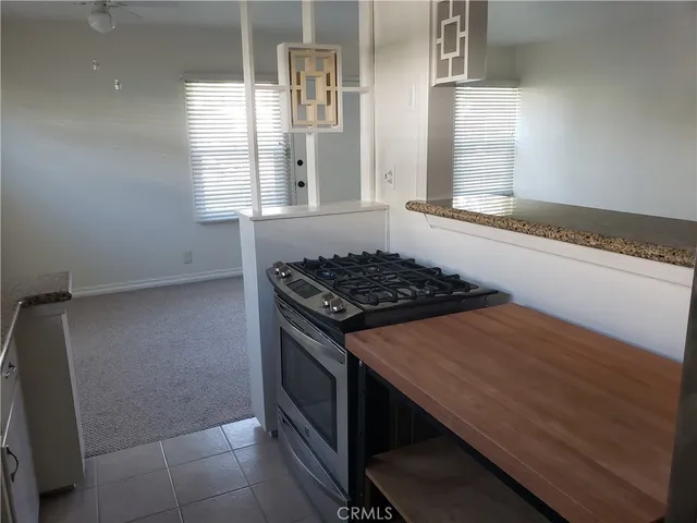 a kitchen with a stove and a window