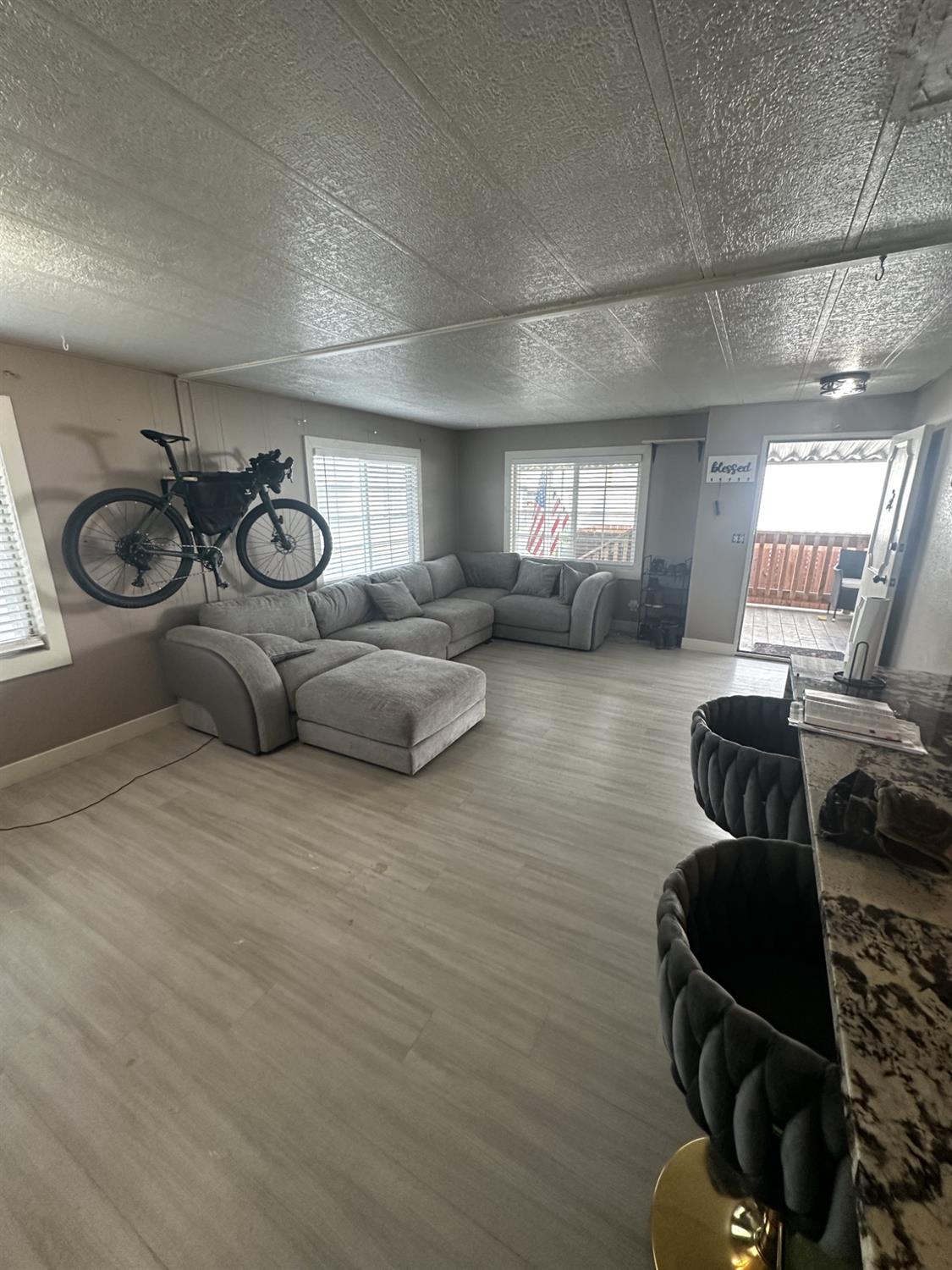 15820 South Harlan Road, Unit 16 Lathrop, CA 95330 - Photo 5 of 16 a living room with furniture a gym equipment and a large window