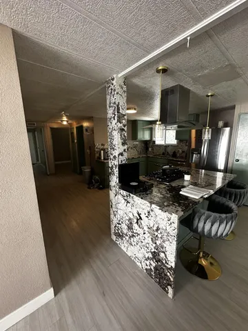 a bedroom with a large bed and a chandelier