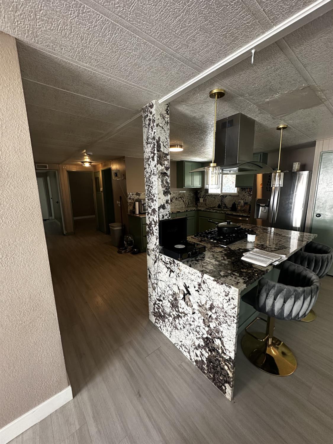 15820 South Harlan Road, Unit 16 Lathrop, CA 95330 - Photo 7 of 16 a kitchen with stainless steel appliances kitchen island granite countertop a stove and a refrigerator