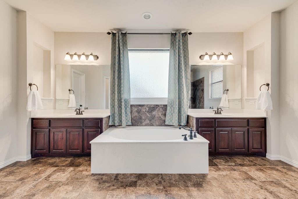 311 Covington Lane Ovilla, TX 75154 - Photo 20 of 29 a spacious bathroom with a tub a sink double vanity and a mirror