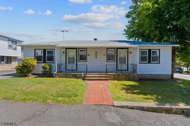 a view of swimming pool with small yard and plants