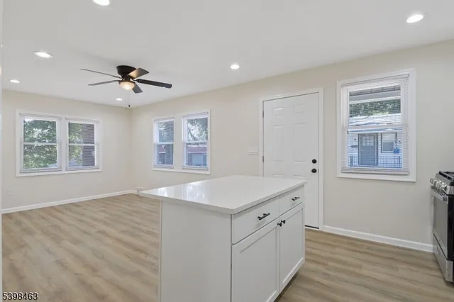 a view of kitchen with center island and windows