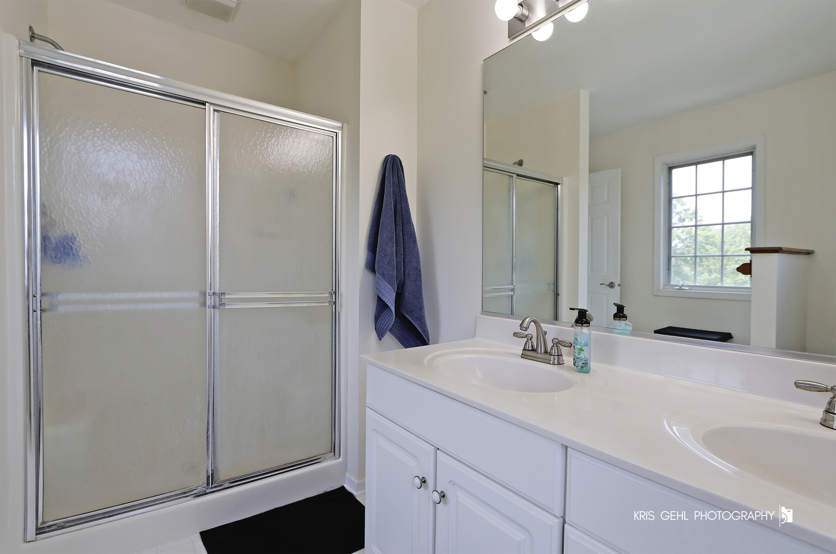1277 Queen Ann Lane Gurnee, IL 60031 - Photo 16 of 25 a bathroom with a double vanity sink and a mirror