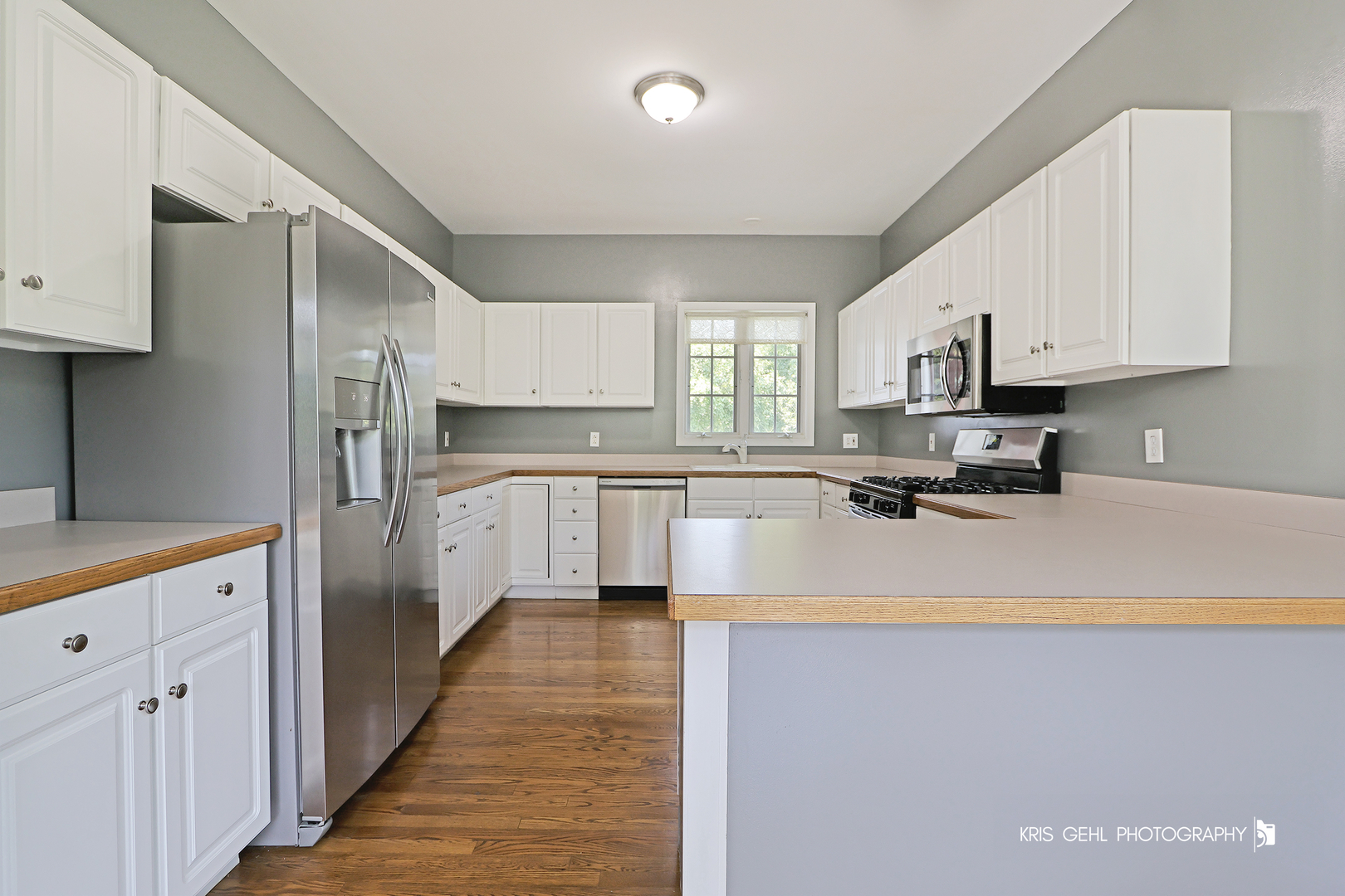 1277 Queen Ann Lane Gurnee, IL 60031 - Photo 6 of 25 a kitchen with stainless steel appliances a refrigerator sink and cabinets