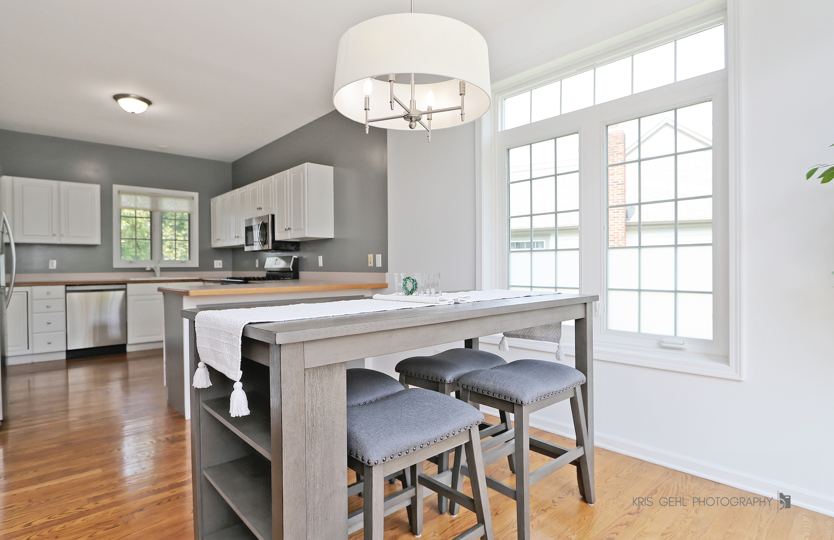 1277 Queen Ann Lane Gurnee, IL 60031 - Photo 9 of 25 a kitchen with a table chairs a sink dishwasher window and cabinets