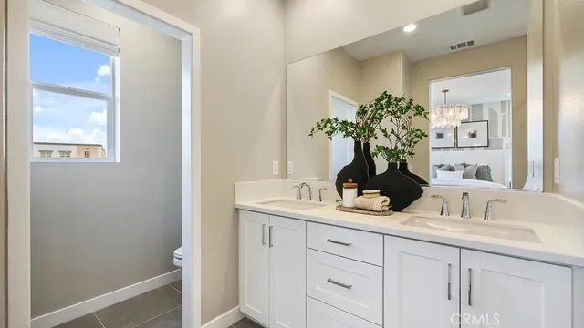 a bathroom with a shower sink vanity and mirror