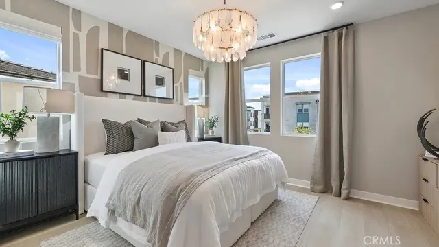 a bedroom with a bed and a chandelier