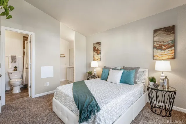 a bedroom with a bed and a view of bathroom