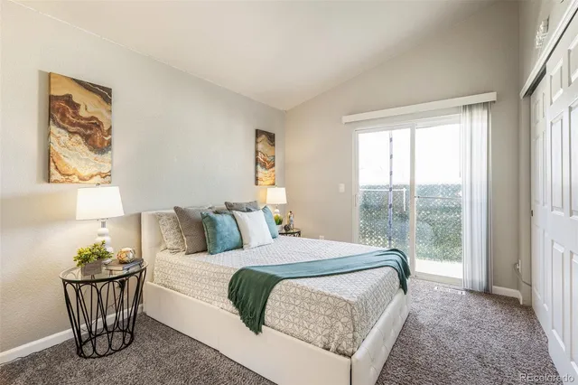 a bedroom with a bed and large window