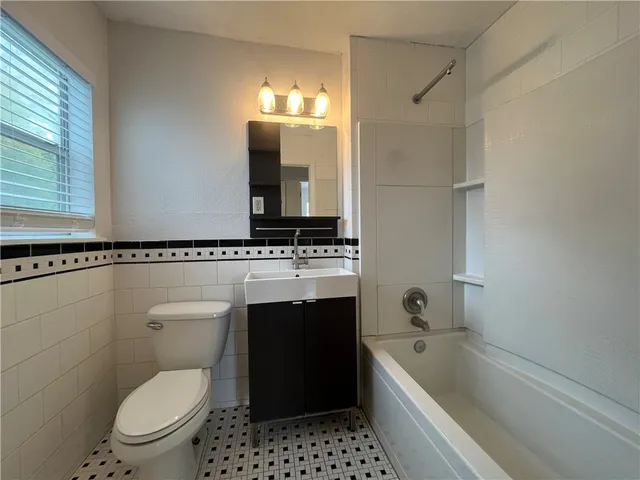 a bathroom with a sink a toilet and a bathtub