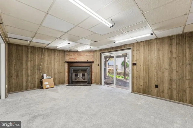 a view of an empty room with a fireplace