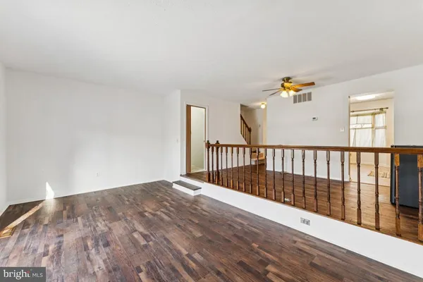 a view of a room with wooden floor