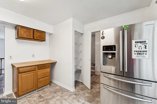 a kitchen with stainless steel appliances granite countertop a refrigerator and a stove