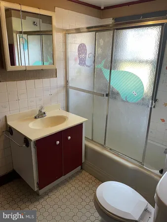 a bathroom with a sink vanity mirror and toilet